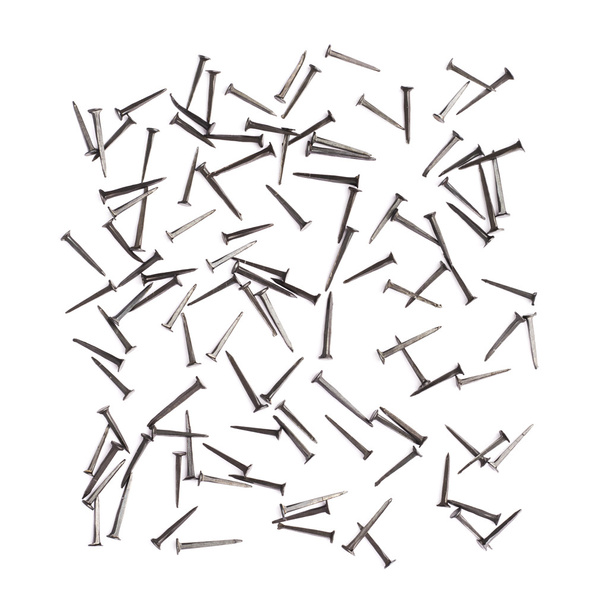 Scattered nails over surface isolated over white background - Foto, imagen
