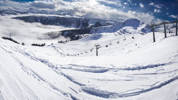 Skiers on ski lift enjoying view - Photo, image
