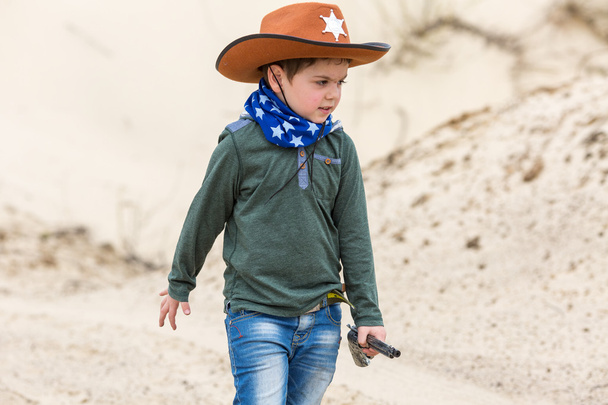 boy in a sheriff hat with a gun - Photo, image