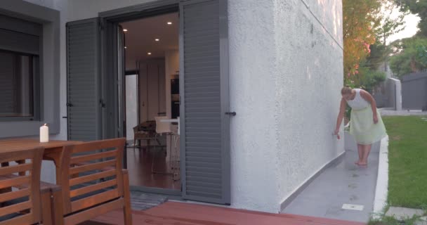 Jovem mulher lavando os pés antes de entrar no apartamento alugado
 - Filmagem, Vídeo