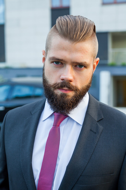 Portrait of a young focused businessman outside the office build - Фото, изображение