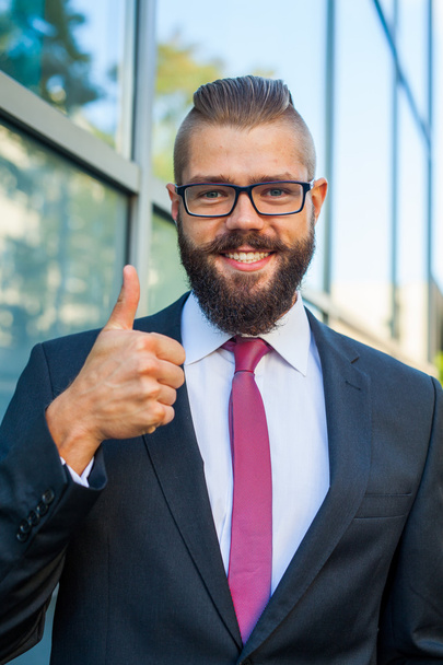 Portrait of a young happy businessman. Thumb up. Positive emotio - Foto, afbeelding