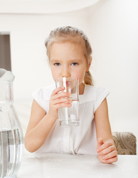 Child with glass pitcher water - Foto, imagen