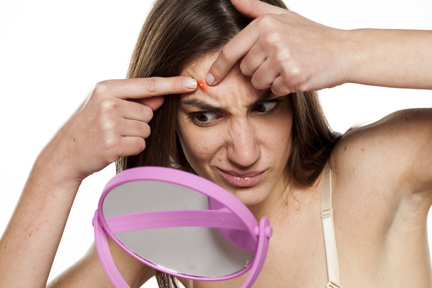 woman squeezing  a pimple - Photo, Image