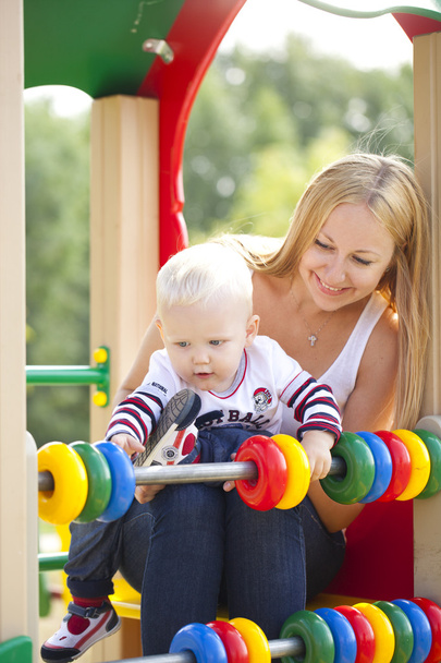 Happy mother with two year old son on the playground - Fotografie, Obrázek