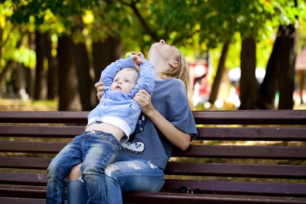 Mother and little son play in summer park  - 写真・画像