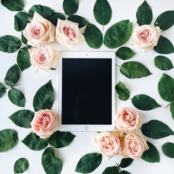 Tablet and pink rose flowers - Photo, Image