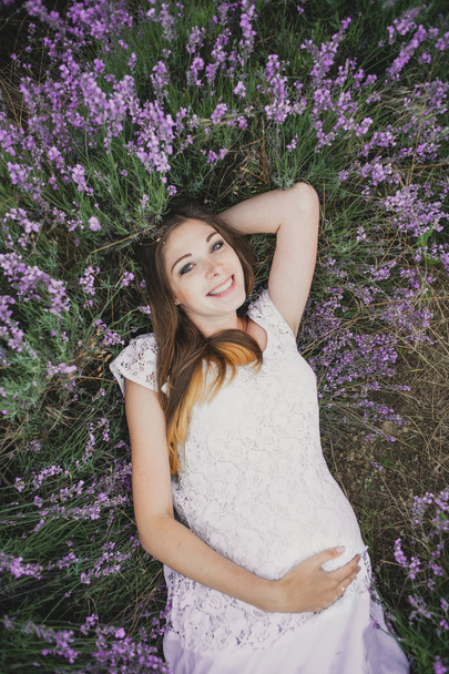 pregnant girl lies in Lavender - Photo, image