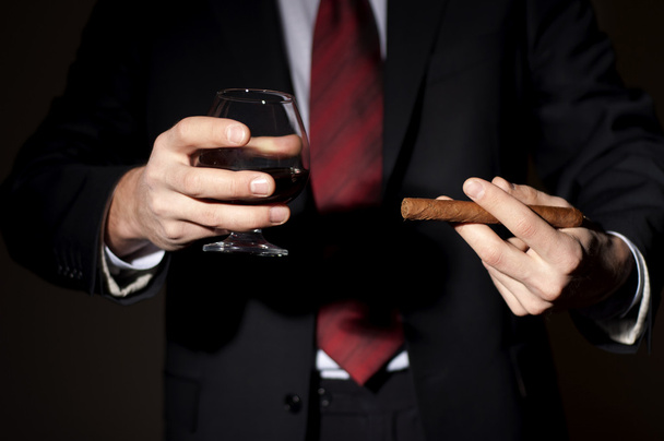 Rich person, holds a cigar and whisky - Φωτογραφία, εικόνα
