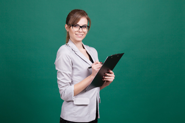 girl teacher with a folder and pen - Zdjęcie, obraz