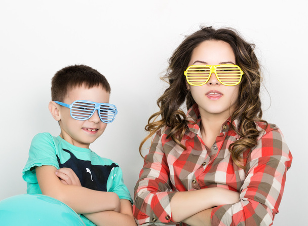 brother and sister, wearing glasses in the style of disco. fold ones arms - Photo, Image