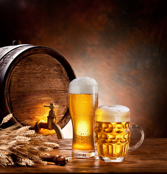 Beer barrel with beer glasses on a wooden table. - Fotó, kép