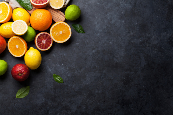 Fresh ripe citruses on stone background - Φωτογραφία, εικόνα