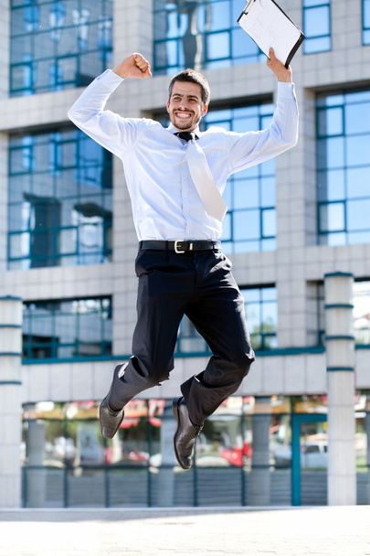 Happy businessman jumps in the air - Fotó, kép