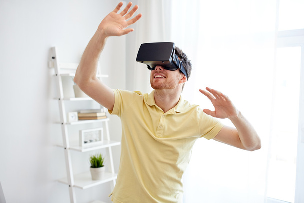 young man in virtual reality headset or 3d glasses - Foto, afbeelding