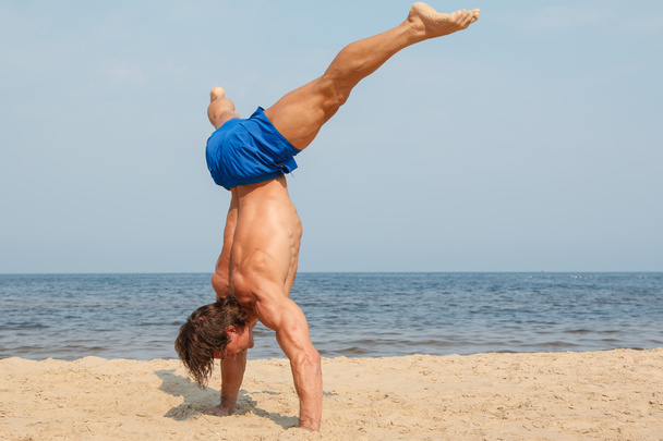 man working out on beach - Photo, Image
