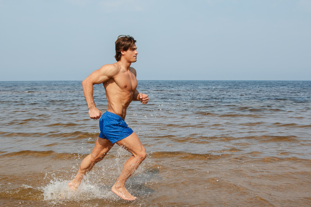 man jogging on sea coast - Фото, зображення