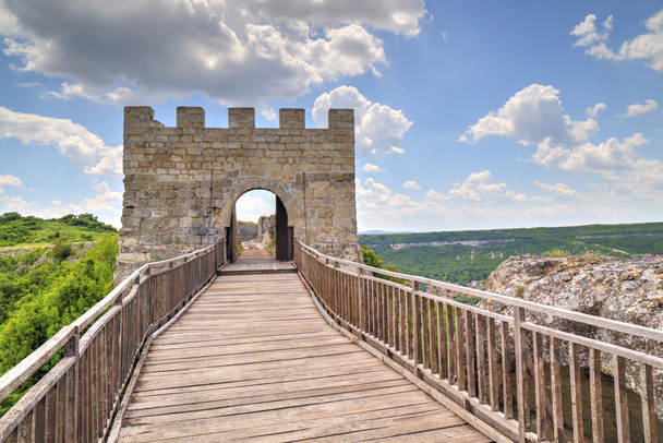 Πέτρινοι τοίχοι και πύλη με ξύλινη γέφυρα στον μεσαιωνικό φρούριο - Φωτογραφία, εικόνα