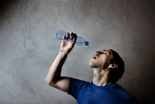 Muscle man drinking water - 写真・画像