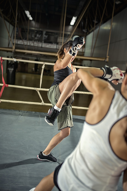 female kick boxer practicing attack - Zdjęcie, obraz
