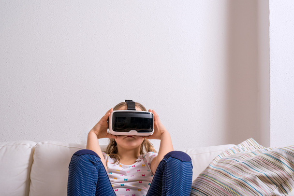 Girl wearing virtual reality goggles. Studio shot, copy space - Фото, зображення
