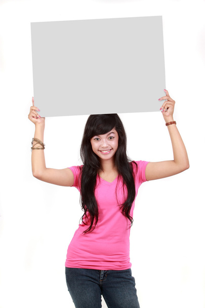 Woman holding a blank board isolated over white background - Фото, изображение