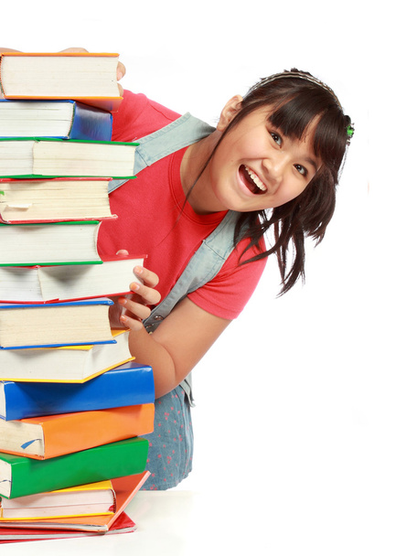 Pile of book with lovely kid behind it smiling - Foto, Bild