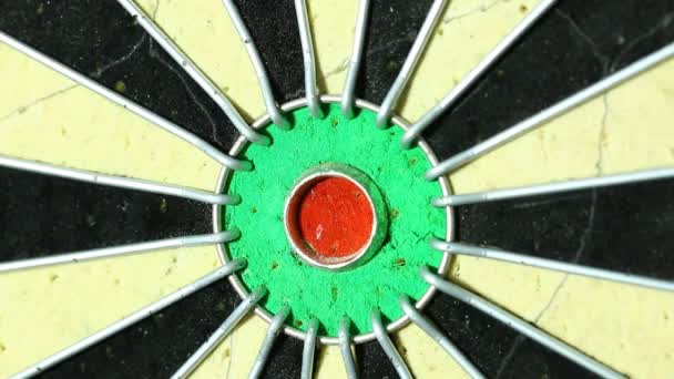A dart strikes the bulls-eye of a dartboard. macro  - Footage, Video
