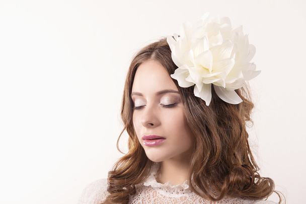 girl in white dress and with white flower in her hair - Photo, Image