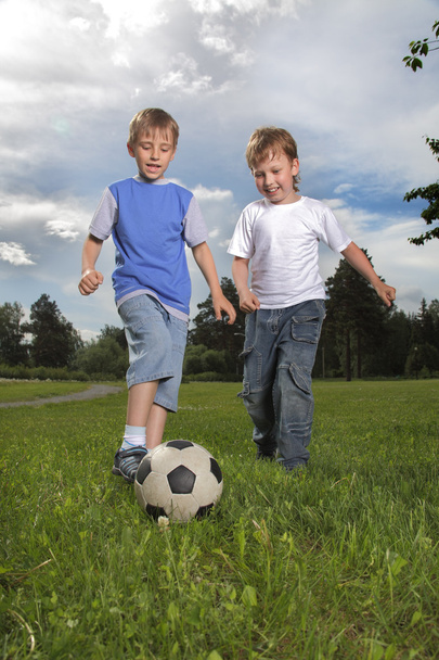 Two happy boy play in soccer - 写真・画像
