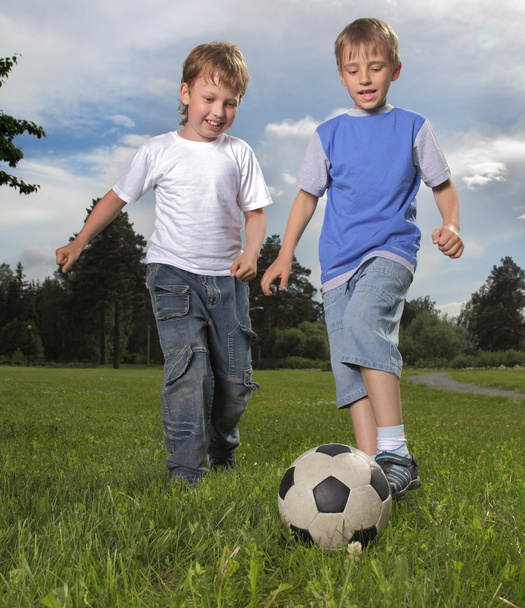 Two happy boy play in soccer - Фото, изображение