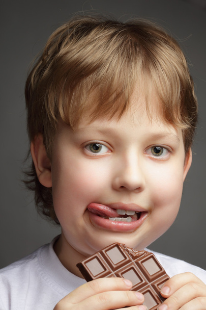 Happy boy with chocolate bar - Photo, image