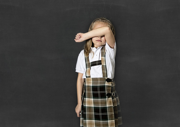  dulce junior colegiala con pelo rubio llorando triste en frente de la escuela aula pizarra
 - Foto, Imagen