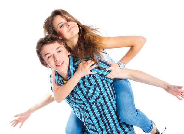 Young man piggybacking his girlfriend - Valokuva, kuva