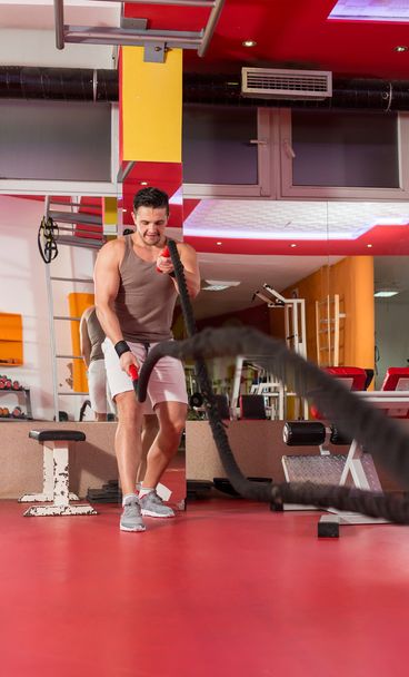 battling ropes man at gym workout exercise fitted body - Fotografie, Obrázek