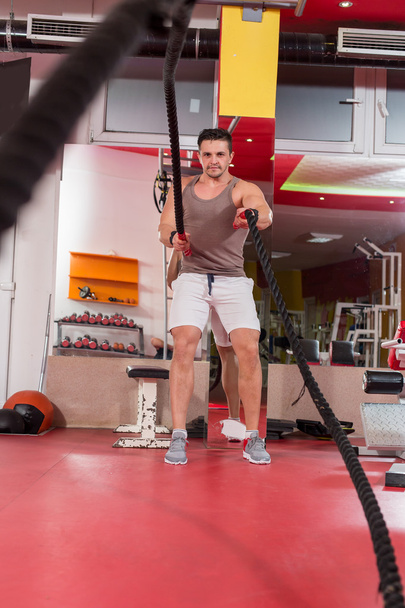 battling ropes man at gym workout exercise fitted body - Φωτογραφία, εικόνα