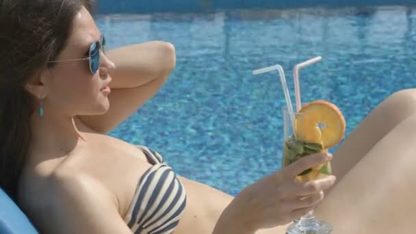 Sexy female enjoying cocktail on sunny beach, flirting, teasing - Felvétel, videó