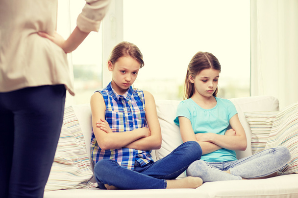 upset guilty little girls sitting on sofa at home - Photo, Image