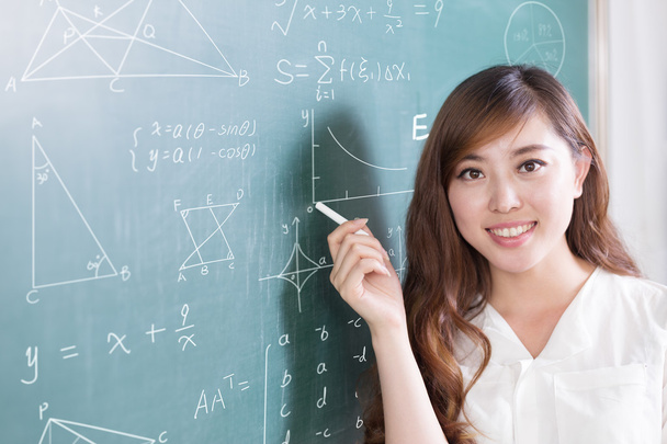 beautiful girl teacher with green blackboard - Φωτογραφία, εικόνα