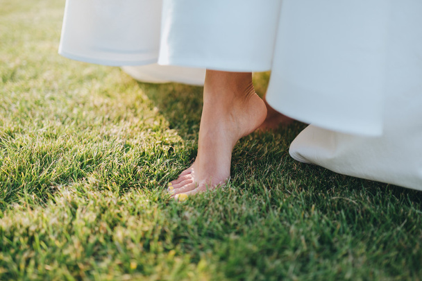 foot of bride in white wedding dress - Фото, изображение