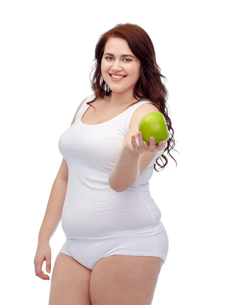 happy plus size woman in underwear with apple - Foto, afbeelding