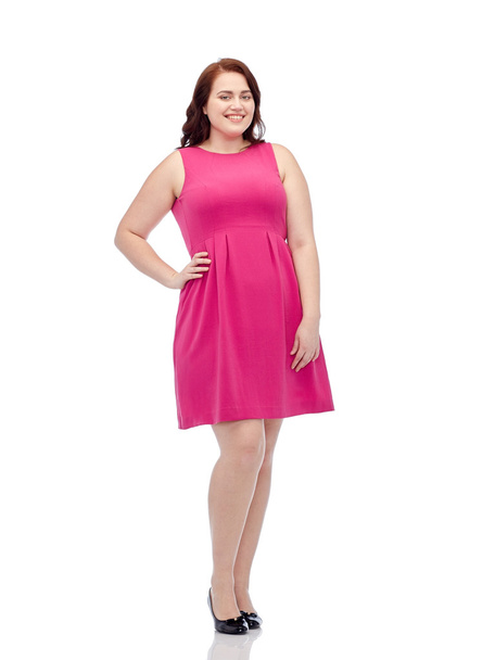 happy young plus size woman posing in pink dress - Фото, изображение