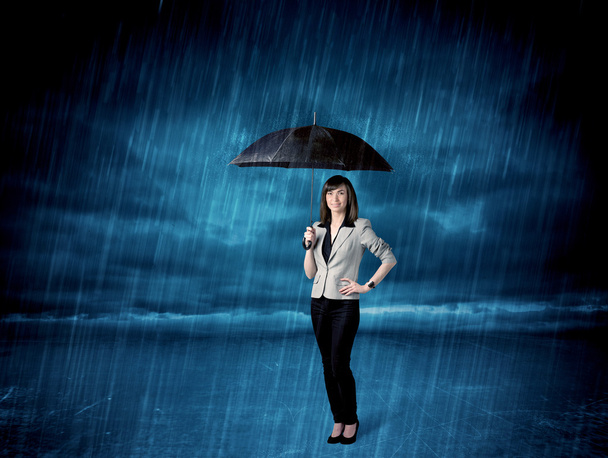 傘と雨の中で立っているビジネス女性 - 写真・画像