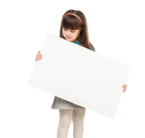 little schoolgirl holding paper blank - Valokuva, kuva