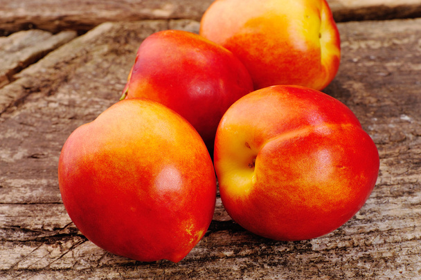 Fresh peaches on the table, delicious, juicy, tasteful - Фото, изображение