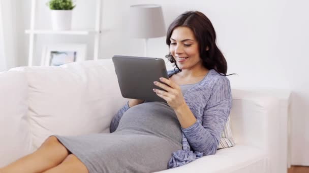 happy pregnant woman with tablet pc at home - Felvétel, videó
