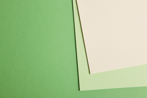 Colored cardboards background in green beige tone. Copy space - Фото, изображение