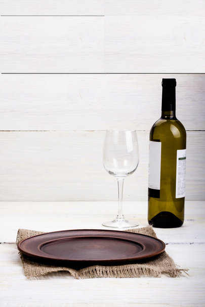 bottle of wine with a glass and a plate - 写真・画像