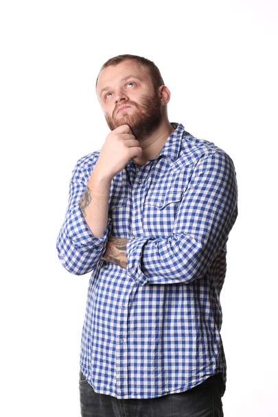 Pensive man with beard standing arms crossed looks into distance - Фото, зображення