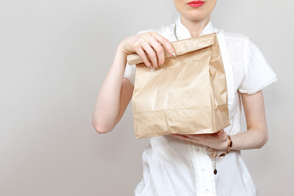 Delivery girl paper bag - Foto, imagen